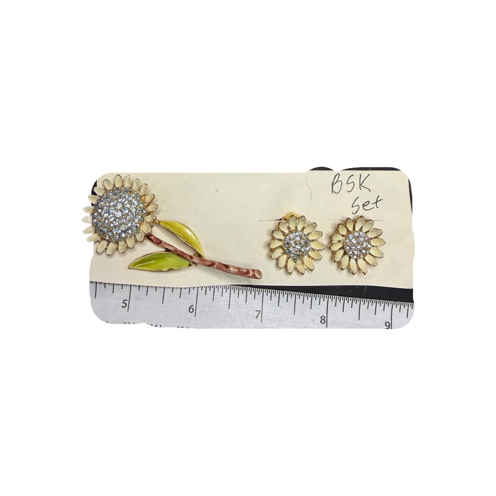 BSK jewelry set features a floral brooch and matching clip-on earrings 1950s